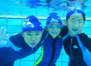 3 children smiling in water