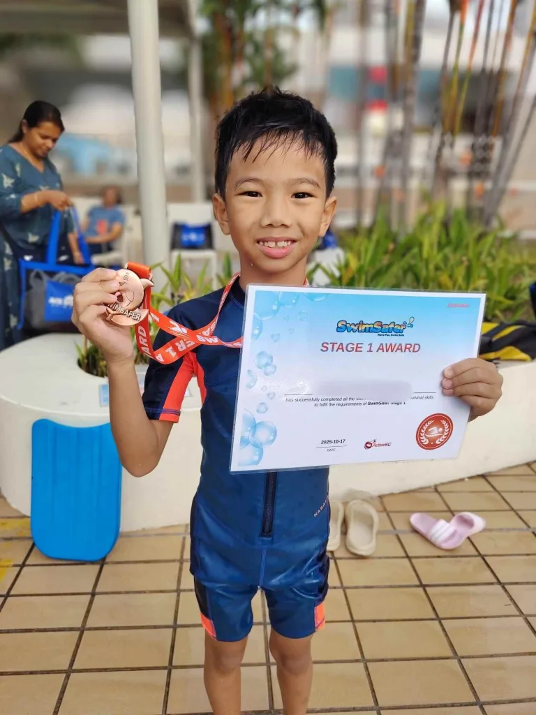 Child passing swimsafer 1 with medal and cert